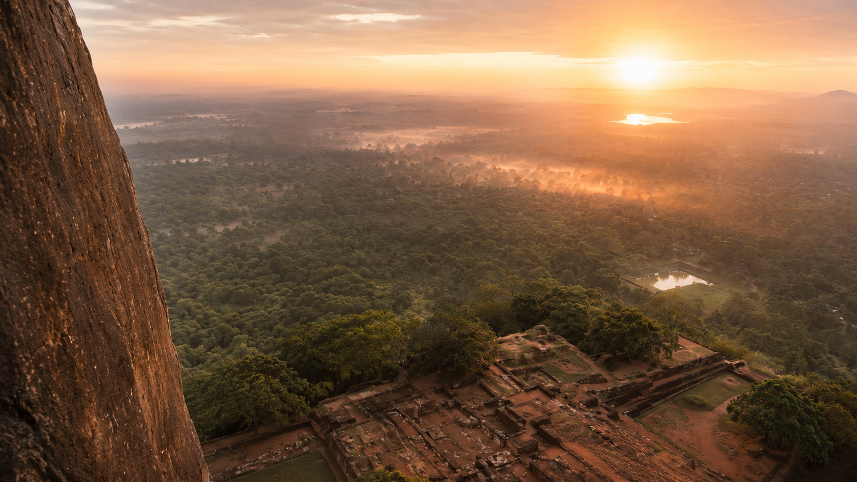 Sunrise view from Sigiriya Lion Rock, overlooking ancient palace ruins and the surrounding forest landscape in Sri Lanka.